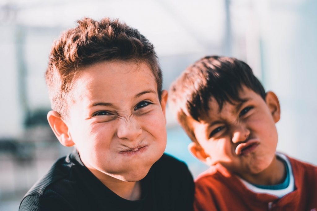 Two kids pulling funny faces