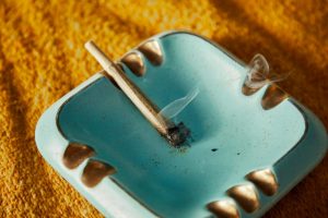 Cannabis blunt on a blue ashtray
